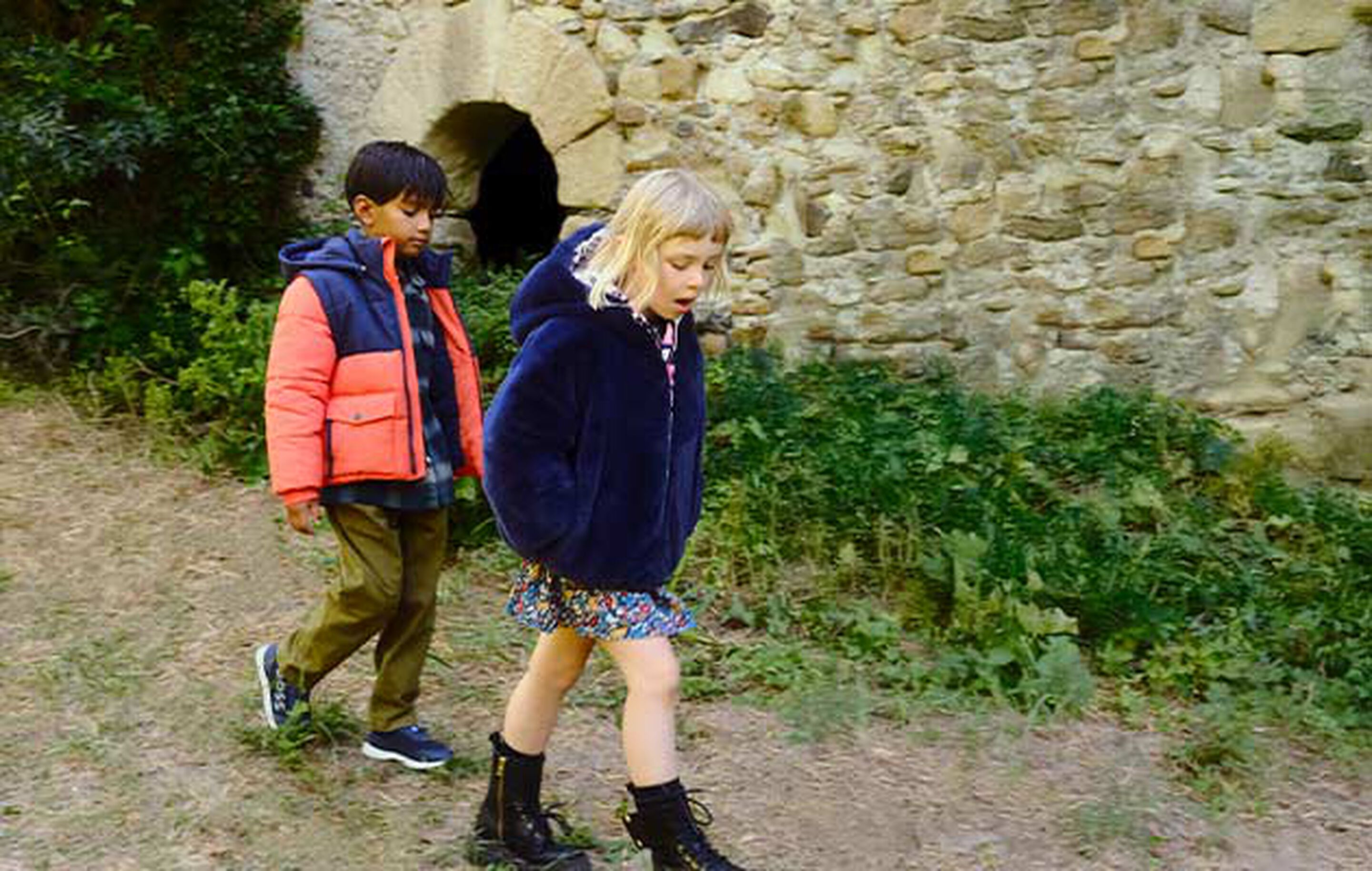 Child wearing a warm coat and Timberland boots in a Scottish countryside setting